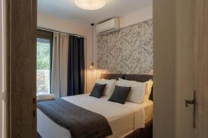 a bedroom with a large bed with a window at Charisma apartments in Nikiana +51 photos