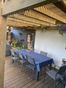 a blue table and chairs on a wooden deck at Maison familiale Tarnos, 4 chambres, jacuzzi in Tarnos
