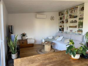 a living room with a couch and a table at Maison familiale Tarnos, 4 chambres, jacuzzi in Tarnos