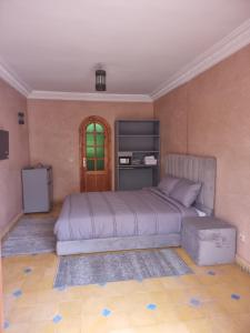 a bedroom with a large bed in a room at Dar Fatna Marrakech in Marrakech