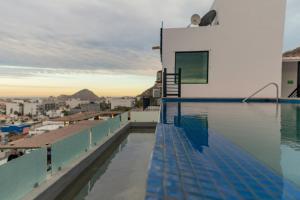 a swimming pool on the roof of a building at The Residences Apart-Hotel By Morgan in Cabo San Lucas