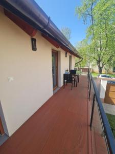 a deck with a table and chairs on a house at 4 Basa Bungalow in Szeged