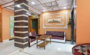 a waiting room with a couch and a table at SPOT ON Hotel River View in Guwahati