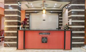 a red counter in a room with stairs at SPOT ON Hotel River View in Guwahati