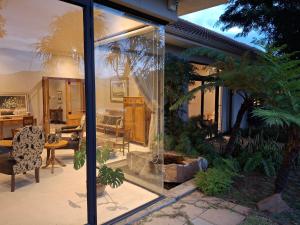 a living room with a large glass window at Riverhide, Private Riverside Villa with Jacuzzi & Mountain Views in Bonnievale
