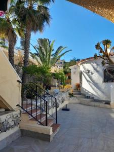 a stairway with palm trees and a building at Casa Katalyna in Orba +22 photos