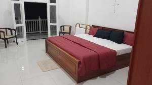 Postel nebo postele na pokoji v ubytování The White House Kandy