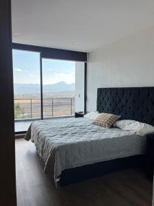 a bedroom with a large bed with a large window at Casa de Campo Morelia-Pátzcuaro in Morelia +46 photos