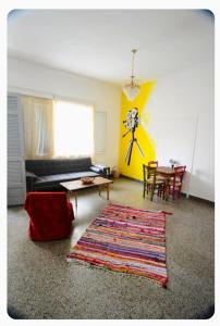 a living room with a couch and a table and a rug at The SPiTi Project 23 in Kavála