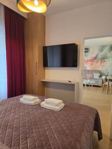 a bedroom with a bed with two towels on it at Boszkowo Horizon Park Apartament 16 "Miętowy" in Boszkowo +5 photos