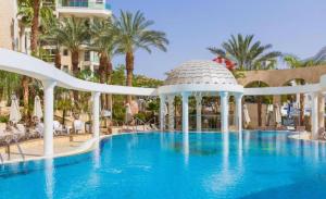 a pool at a resort with a gazebo at Golf Residence Suite & pool in Eilat