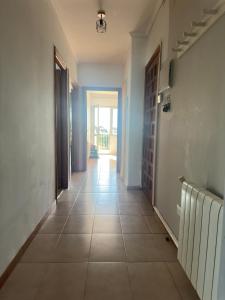 an empty hallway with a tile floor and a door at CASA Nieves in O Grove
