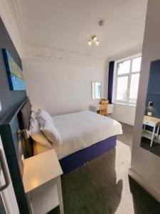 a small bedroom with a bed and a window at At Caledonia in Douglas