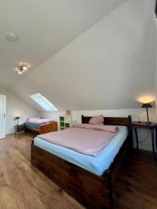 a bedroom with a large wooden bed and a table at Ferienwohnung Ostseefeuer in Eutin