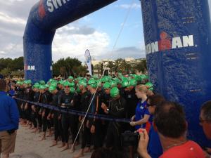 a large group of people in green helmets lined up at Hostal Brisa Marina in Port d'Alcudia
