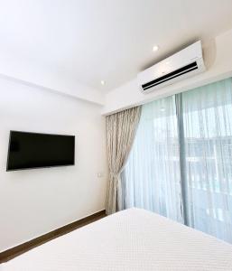 a bedroom with a flat screen tv and a bed at 1 bed Apartment in Osu - Accra, Ghana - Solaris Apartments in Accra +10 photos