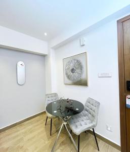 a dining room with a glass table and two chairs at 1 bed Apartment in Osu - Accra, Ghana - Solaris Apartments in Accra