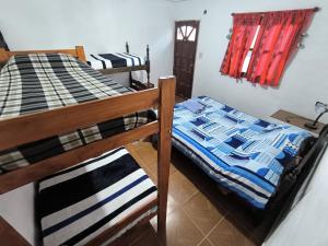 Una cama o camas en una habitación de Hostel VERBENITA