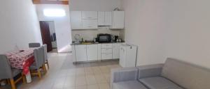 a kitchen and a living room with a couch and a table at Apartment for 2 people - Erezcano two in Adrogué