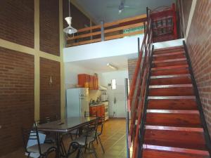 a kitchen and dining room with a staircase and a table at Cabañassoleado Villa Cura Brochero in Villa Cura Brochero