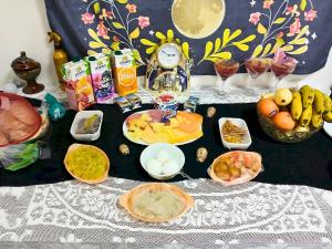 a table with food and other foods on it at Gadou Rooms -Private & Shared Stays in Port Said Best Location in Port Said