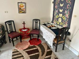 a dining room with a table and two chairs at Gadou Rooms -Private & Shared Stays in Port Said Best Location in Port Said
