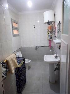 a bathroom with a sink and a toilet at Gadou Rooms -Private & Shared Stays in Port Said Best Location in Port Said