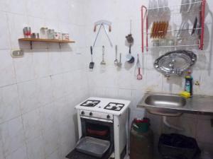 a small kitchen with a stove and a sink at Gadou Rooms -Private & Shared Stays in Port Said Best Location in Port Said