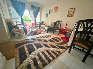 a living room filled with furniture and a rug at Gadou Rooms -Private & Shared Stays in Port Said Best Location in Port Said