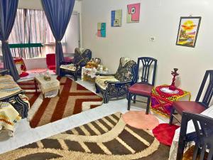a living room filled with chairs and a rug at Gadou Rooms -Private & Shared Stays in Port Said Best Location in Port Said