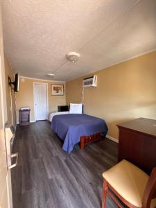 a hotel room with a bed and a table at CMI Hotel 1935 Myrtle Beach SC in Myrtle Beach