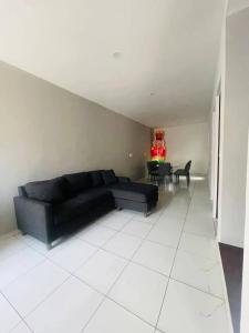 Una sala de estar con un sofá negro y una mesa. en San Angel, en Topilejo