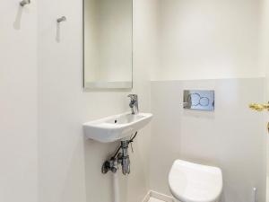 a white bathroom with a sink and a toilet at 6 person holiday home in Gilleleje-By Traum in Gilleleje +28 photos
