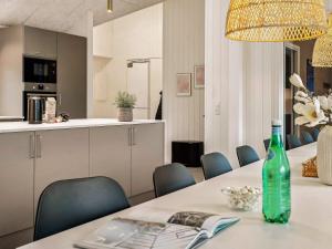 a dining room with a table with a green bottle on it at 5 star holiday home in Sydals in Sarup +41 photos