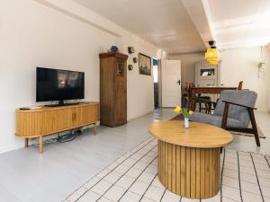 a living room with a flat screen tv on a wooden table at 6 person holiday home in Marstal in Marstal