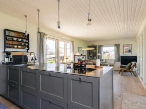 a kitchen with a large island in the middle at Panoramic Retreat in Borgnaes - By Traum Ferienwohnungen in Ærøskøbing