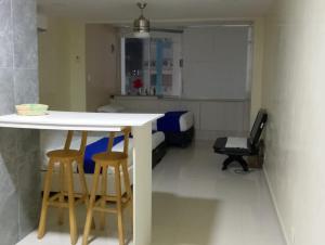 a kitchen with a table and two stools in a room at Toscana Suite 3009 in Las Margaritas