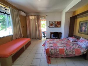 ein Schlafzimmer mit einem Bett und einem Schreibtisch darin in der Unterkunft Casa Aconchego in Aracaju