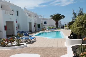 a swimming pool in the middle of a resort at Cactus in Puerto del Carmen