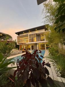 a large building with a swimming pool in front of it at Tomeizah in Sampong