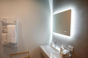 a white bathroom with a sink and a mirror at LN 5 Gate-Corso Italia in Catania +41 photos