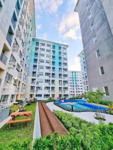 an apartment complex with a pool and two tall buildings at Seawind Condominium in Davao City