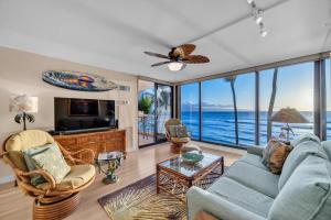 a living room with a view of the ocean at Mahana 305 in Kahana