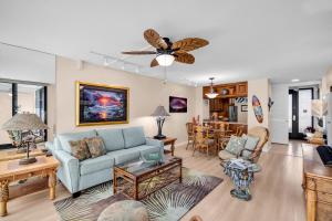 a living room with a couch and a table at Mahana 305 in Kahana