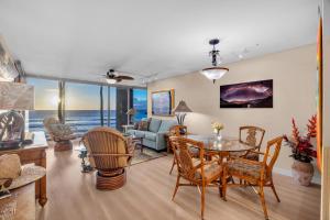 a living room with a table and chairs at Mahana 305 in Kahana