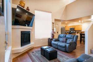 a living room with a couch and a fireplace at Moab Adventure Basecamp in Moab