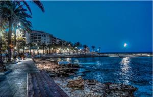 a beach with palm trees and a body of water at Awesome Apartment In Torrevieja in Torrevieja +11 photos