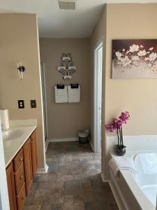 a bathroom with a tub and a sink and a toilet at Nice and Simple Country Home in Winston-Salem