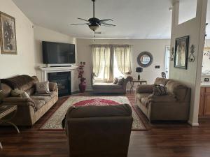 a living room with two couches and a tv at Nice and Simple Country Home in Winston-Salem