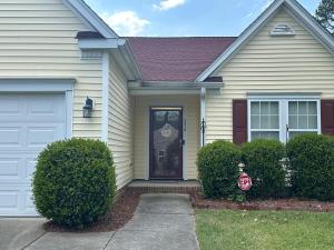 a white house with a white door and bushes at Nice and Simple Country Home in Winston-Salem